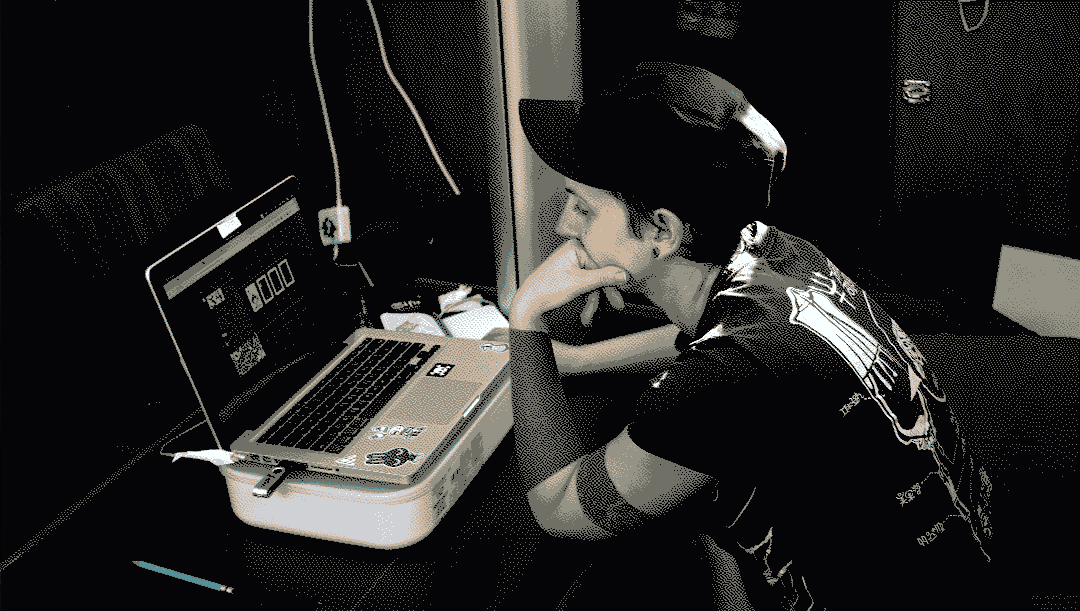 a photo of Rekka working on the game Donsol using Vincent, a Macbook pro